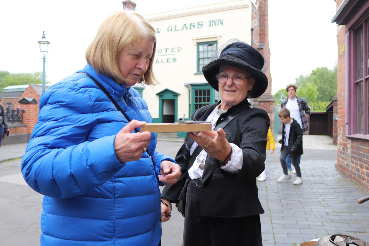 Historic Character describing an object to a blind and partially sighted visitor
